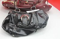 Front view of both handbags showing overall style and hardware