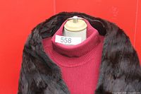 Front view of brown fur shawl draped on mannequin