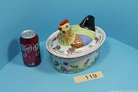 Full tureen with lid beside soda can for scale