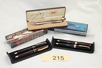 Overall view of five boxed pen sets