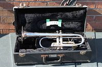 Bugle trumpet inside open case, full view