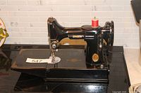 Full view of Singer Featherweight sewing machine on surface