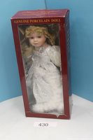 Boxed porcelain doll front view showing doll and packaging