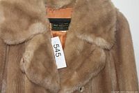 Close-up of collar, faux fur texture, tag number visible