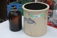 stoneware crock and amber glass jug side by side