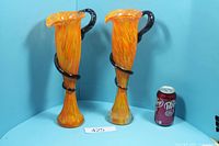 Pair of orange art glass vases beside soda can for scale