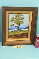 Front view of framed oil painting with beverage can for scale