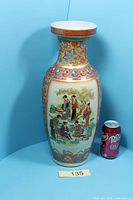 Front view of tall decorated Satsuma vase with soda can for scale