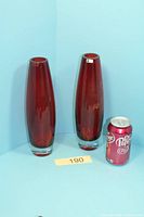 Both red vases side by side with soda can for scale