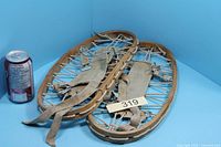 Both snowshoes next to soda can for scale