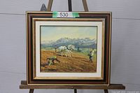 Framed oil painting on easel showing full view