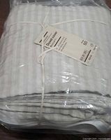 Factory packaged beige seersucker duvet cover tied with cotton string
