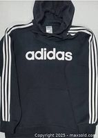 Front view showing adidas logo, sleeve stripes, pocket