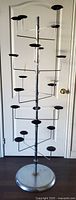 Full view of chrome hat display stand with 20 holders