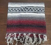 Blanket folded showing stripe pattern and fringe