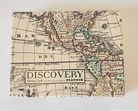 Box top showing Discovery map playing cards branding