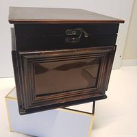 Closed wood photo box showing front frame and clasp