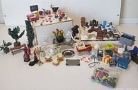 Overview of entire assortment of dollhouse accessories displayed