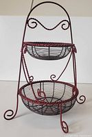 Full view of two-tier metal wire basket stand showing overall structure