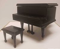 front view of piano with bench