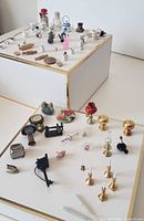 Overall view showing majority of kitchenware and household miniatures on two tiers