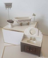 Full view of bathtub, toilet, sink cabinet, and freestanding faucet