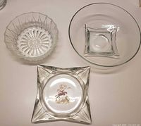 Three glass items: pressed glass bowl, clear round bowl, square hunting-theme ashtray