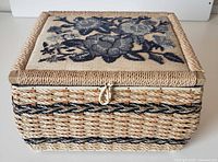 Front view of wicker Singer sewing basket showing clasp and handle