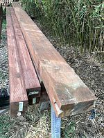 Stack of treated 4×4 and 4×6 showing ends and weathering