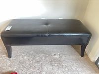 Front view of black faux leather bench