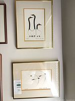 Both framed Benjamin Chee Chee prints on wall