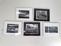 Overall view of five framed photographs on wall