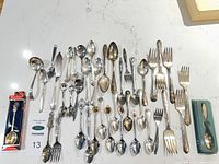 Full lot overview showing all flatware pieces laid out