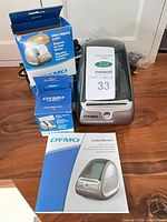 Printer with two label boxes and cables visible