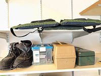 Full lot on shelf: boots, three tackle boxes, two Redington cases