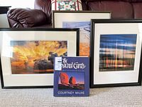 Overview of all three framed prints and book
