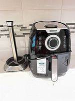 Kalorik air fryer and paper towel holder on countertop