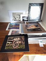 Stack of matted photo prints on table