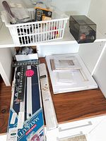 Shelf with framing tools, mat cutter parts, clamp, accessories