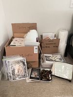 Overall shot of packed boxes, clear bins, foam roll, bubble roll and pattern packets