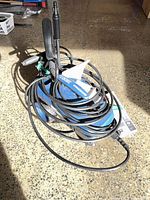 Entire pressure washer with hose and spray gun coiled on top