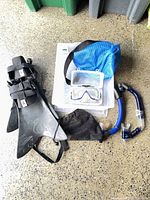 Group shot of fins, mask in case, snorkels, mesh bags