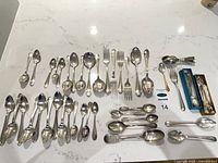All flatware pieces laid out for count and pattern visibility