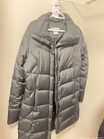 Front view of grey Columbia 3⁄4 puffer coat on hanger