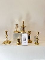 Front view of all six brass candlesticks