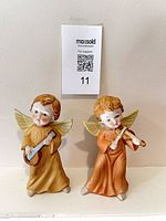 Both ceramic angel figurines front view