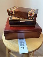 All three boxes stacked showing tops and decorative details