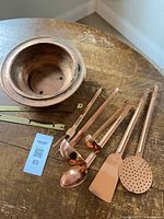 Overall lot showing copper chafing dish, six utensils and brass hanger