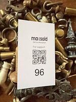 Pile of assorted lamp finials with QR card