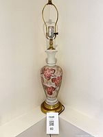 Full view of glass table lamp with harp and finial